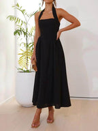 Vestido midi negro de cintura baja con cuello halter